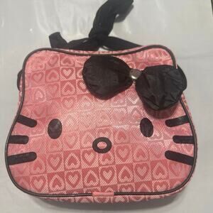 Hello Kitty Pink crossbody bag vinyl with a black bow and all-over heart print.